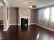 A living room with hardwood floors, a black fireplace, and sheer curtains at 141 Steel Hopper Way, Garner, NC 27529