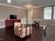 A living room with hardwood floors, a red TV stand, and an armchair at 141 Steel Hopper Way, Garner, NC 27529