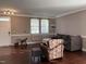 A living room with hardwood floors, a gray couch, and an armchair at 141 Steel Hopper Way, Garner, NC 27529