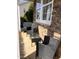 Covered front porch with black wicker seating set, stone exterior, and a cozy, inviting atmosphere at 141 Steel Hopper Way, Garner, NC 27529