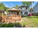 Expansive backyard with a well-maintained deck, screened porch, and lush greenery at 1433 Deltona Dr, Raleigh, NC 27615