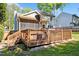 Backyard featuring a spacious deck and screened-in porch, perfect for outdoor entertaining at 1433 Deltona Dr, Raleigh, NC 27615
