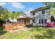 The backyard features a large deck and screened porch with a well-maintained lawn at 1433 Deltona Dr, Raleigh, NC 27615