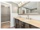 Spacious Primary bath with double sinks, dark cabinets, and access to walk-in closet at 1433 Deltona Dr, Raleigh, NC 27615