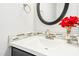 Elegant half bathroom with modern sink, chrome faucet, and mosaic backsplash at 1433 Deltona Dr, Raleigh, NC 27615