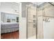 Modern bathroom featuring a glass shower with elegant tile work, a bedroom view at 1433 Deltona Dr, Raleigh, NC 27615