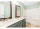 Bathroom featuring double sinks with bathtub and shower combination at 1433 Deltona Dr, Raleigh, NC 27615