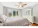 Serene bedroom showcasing a large window, hardwood floors, and a white dresser at 1433 Deltona Dr, Raleigh, NC 27615