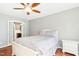 Charming bedroom with hardwood floors and a view to an adjoining bathroom at 1433 Deltona Dr, Raleigh, NC 27615