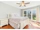 Bright bedroom featuring hardwood floors, ceiling fan, and a sun-drenched window view at 1433 Deltona Dr, Raleigh, NC 27615