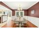Elegant dining room with modern chandelier and wood floors at 1433 Deltona Dr, Raleigh, NC 27615