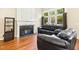 Cozy living room with a fireplace and hardwood flooring at 1433 Deltona Dr, Raleigh, NC 27615