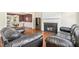 Living room with fireplace, hardwood floors, and dining room access at 1433 Deltona Dr, Raleigh, NC 27615