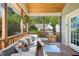 Inviting screened-in porch offers a cozy seating area and serene views of the surrounding landscape at 1433 Deltona Dr, Raleigh, NC 27615