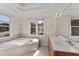 Luxurious bathroom featuring a soaking tub, double sinks, and natural light at 1526 Town Home Dr, Apex, NC 27502
