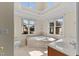 Bright bathroom with a corner tub, large window, and neutral tile at 1526 Town Home Dr, Apex, NC 27502