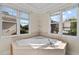 Bathroom with soaking tub under natural light at 1526 Town Home Dr, Apex, NC 27502