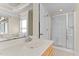 Bright bathroom features a shower, and a large mirror reflecting the toilet and doorway at 1526 Town Home Dr, Apex, NC 27502