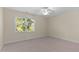 Carpeted bedroom with a window letting in natural light at 1526 Town Home Dr, Apex, NC 27502