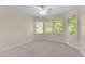 Cozy bedroom featuring light neutral walls and natural lighting from the windows at 1526 Town Home Dr, Apex, NC 27502