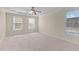 Spacious bedroom featuring light neutral walls and natural lighting from the windows at 1526 Town Home Dr, Apex, NC 27502