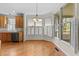 Eat-in kitchen area with hardwood floors, plantation shutters, and a view to the outdoor deck at 1526 Town Home Dr, Apex, NC 27502