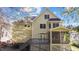 Lovely rear exterior view of home with deck, screened porch, and neutral siding, surrounded by mature trees at 1526 Town Home Dr, Apex, NC 27502