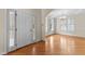 Bright foyer featuring hardwood floors, a chandelier, and an adjacent living area at 1526 Town Home Dr, Apex, NC 27502