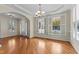Bright living room with hardwood floors, large windows with plantation shutters, and elegant molding at 1526 Town Home Dr, Apex, NC 27502