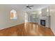 Living room boasting hardwood floors, arched doorways, and a cozy fireplace with marble surround at 1526 Town Home Dr, Apex, NC 27502