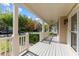Inviting covered porch with white railings, ceiling fan, and ample space for relaxing at 1526 Town Home Dr, Apex, NC 27502