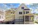 View of the rear exterior of the home, with a screened-in porch and a deck at 1526 Town Home Dr, Apex, NC 27502