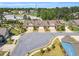 Aerial view of townhomes with well manicured lawns, driveways, and lush greenery surrounding the area at 153 Telluride Trl, Garner, NC 27529