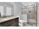 This bathroom boasts a granite vanity, toilet and walk-in shower with glass enclosure and tiled walls at 153 Telluride Trl, Garner, NC 27529