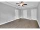 This bedroom features a ceiling fan, tray ceiling and three doors allowing access to other spaces at 153 Telluride Trl, Garner, NC 27529