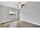 Bedroom with hardwood floors, neutral paint and good natural light from a large window at 153 Telluride Trl, Garner, NC 27529