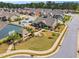 Aerial view showcases a clubhouse with a garden, gazebo, and landscaped walkway at 153 Telluride Trl, Garner, NC 27529