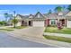 Street view of homes featuring two-car garages, stone accents and manicured lawns at 153 Telluride Trl, Garner, NC 27529