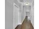 Hallway with hardwood floors, white doors and trim, and neutral walls at 153 Telluride Trl, Garner, NC 27529