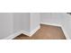 This hallway showcases wood floors, white baseboards, and a view of a closet with wire shelving at 153 Telluride Trl, Garner, NC 27529
