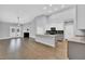 Open concept living room with kitchen island, fireplace and French doors to outside at 153 Telluride Trl, Garner, NC 27529