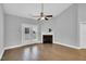 Bright living room with a fireplace, ceiling fan, wood flooring, and double doors to the outside at 153 Telluride Trl, Garner, NC 27529