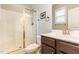 Bright bathroom with a glass-enclosed shower, vanity, and a window for natural light at 178 Cullen Ct, Clayton, NC 27520