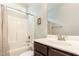 A clean bathroom with a shower and tub combination, plus a dark wood vanity at 178 Cullen Ct, Clayton, NC 27520