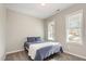 This bedroom has two windows and a comfortable bed with blue bedding at 178 Cullen Ct, Clayton, NC 27520
