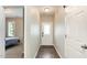 Bright entryway featuring wood floors, a white front door, and an open view into a bedroom at 178 Cullen Ct, Clayton, NC 27520