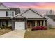 Charming home featuring gray siding, stone accents, a red front door, and a well-manicured lawn at 178 Cullen Ct, Clayton, NC 27520