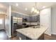 Modern kitchen featuring stainless steel appliances, gray cabinets, and granite countertops at 178 Cullen Ct, Clayton, NC 27520