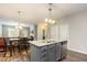 Stylish kitchen island with granite countertops and view of the living and dining areas at 178 Cullen Ct, Clayton, NC 27520
