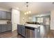 Well-equipped kitchen island with stainless steel dishwasher and view of the living area at 178 Cullen Ct, Clayton, NC 27520